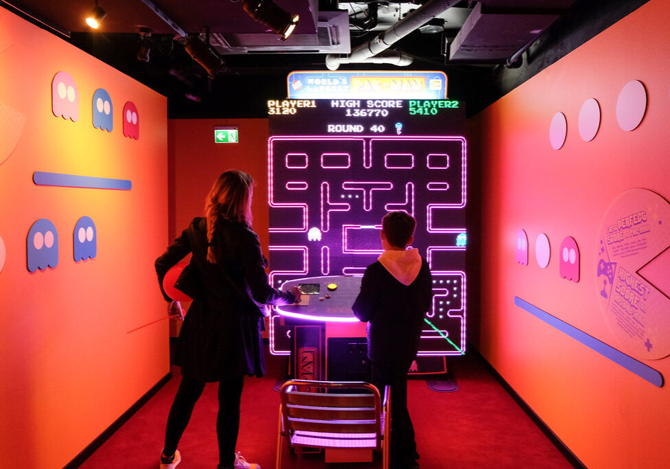 woman and child playing lifesized pacman